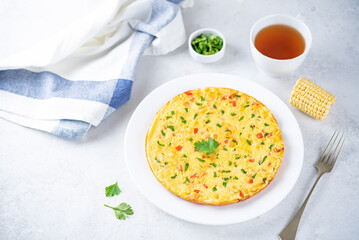 Corn onion red bell pepper omelette in a plate