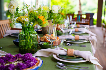 beautiful setting of a large table with flowers. 