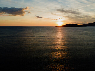 Fototapeta premium Travel. Sunset sun in the sea. Aerial view.