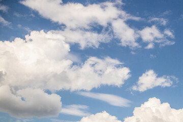 Fluffy clouds in blue Alaskan sk