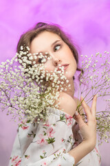 Close up of happy woman smelling wild flowers. Female being with nature