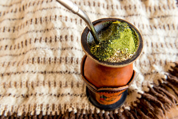 Gaucho tradition, poncho and chimarrao of yerba mate tea.