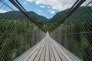 Obraz premium Suspension bridge in Muhlebach, over the Rhone river