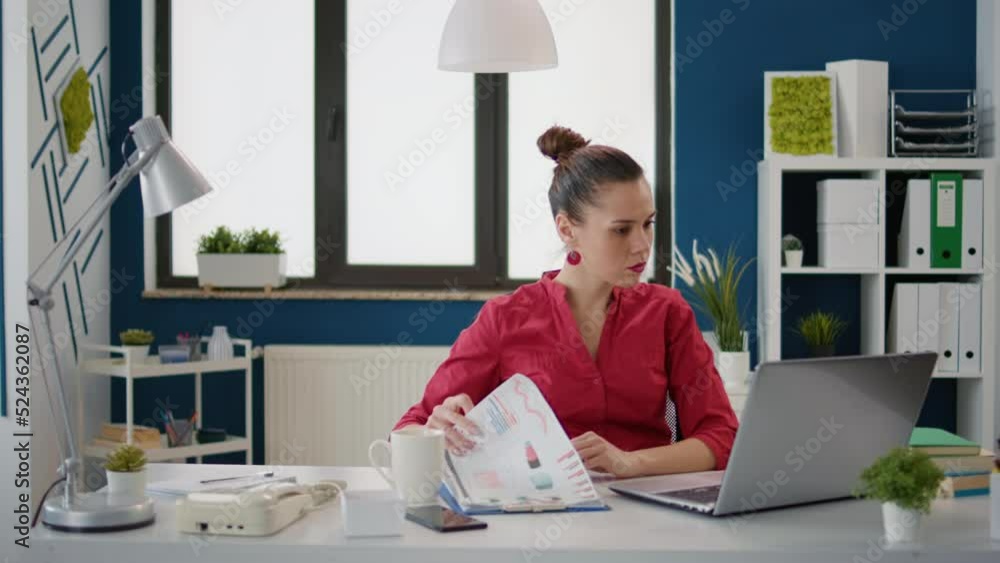 Poster professional assistant analyzing financial statistics on files and laptop, using marketing report to