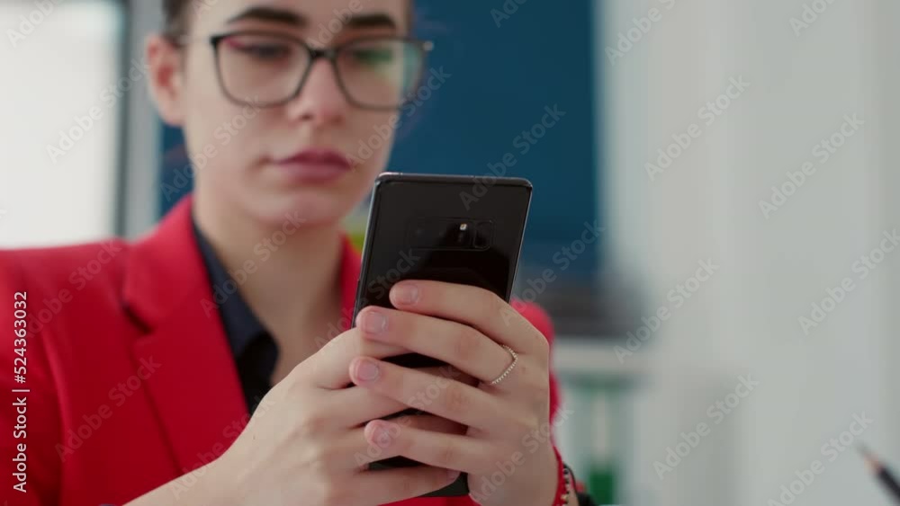 Poster office worker browsing internet on smartphone at desk, texting messages on break after working with 