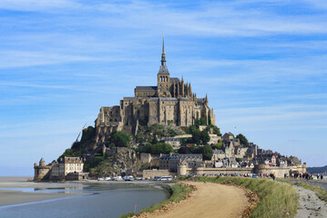 Fototapeta na wymiar Beautiful panoramic view of famous Le Mont Saint-Michel tidal island with blue sky. Normandy, northern France