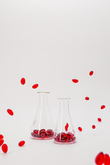 Krill oil capsules in laboratory transparent flasks on a white background.natural omega three...