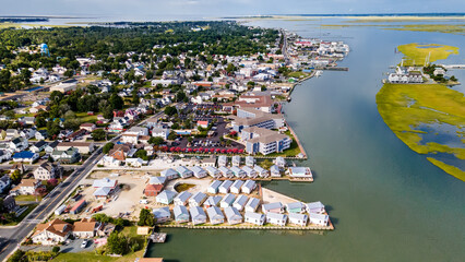 View of Chincoteague Island and the road along the bay. Houses and motels with parking lots. View...
