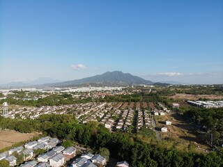Aerial shot of residential areas in Philippines overlooking a mountain