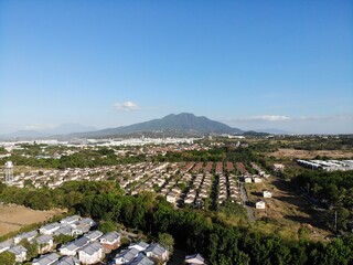 Aerial shot of residential areas in Philippines overlooking a mountain