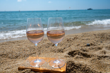 Cold rose wine from Provence served outdoor on white sandy beach Plage de Pampelonne near Saint-Tropez, France