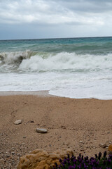 Stormy sea, high waves on yellow sandy beach in Cassis, Provence, France