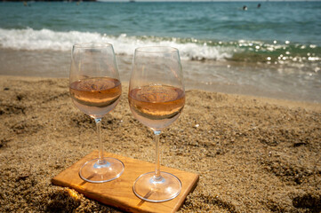 Cold rose wine from Provence served outdoor on white sandy beach Plage de Pampelonne near Saint-Tropez, France