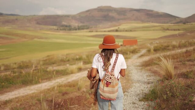 Backpacker tourist walking in peruvian fields in the andes 