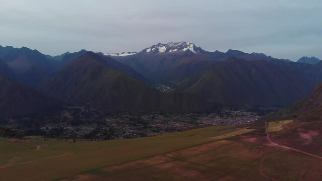 Aerial panorama of peruvian mountains with town on bottom near Cusco 