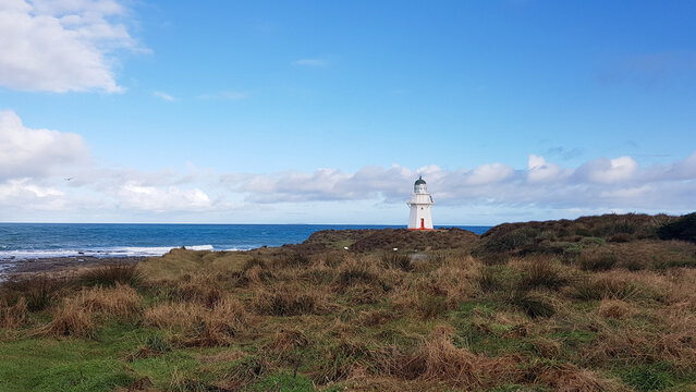 Lighthouse on the coast of the sea, Waipapa Point, New Zealand