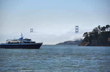 California- Tiburon- Panorama of The Golden Gate Bridge in Fog With Ferry Passing in Foreground