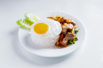 Crispy Pork Basil with Egg in white dish on white background, Thai food, isolated background