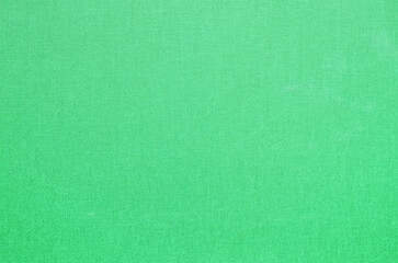Close-up texture of natural weave cloth. Emerald green fabric background. Natural cotton textile material.