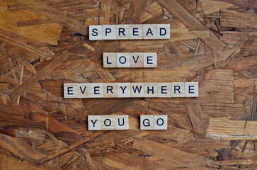 spread love everywhere you go text on wooden square, motivation and inspiration quotes