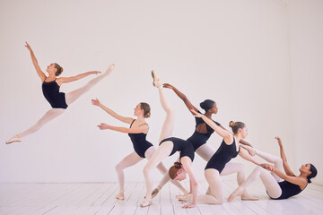 Group of contemporary or ballet dancers performing a unique sequence in a studio. Team of modern...