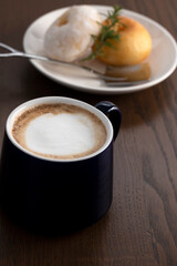 hot coffee with donuts on wooden table