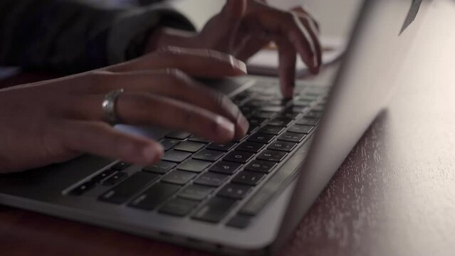 Very close up frame of a Native American student typing on a computer.