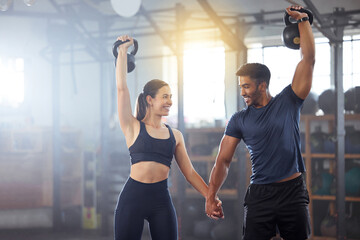 Fitness, kettlebell and couple in a workout exercise and holding hands in a gym. Fit sports people...
