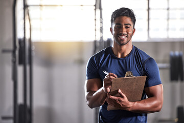 Gym, workout and personal trainer with clipboard consulting at a training sports in gym. Portrait...
