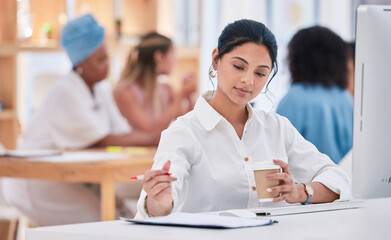 Fototapeta premium Business intern writing notes, planning ideas and brainstorming while working on strategy in a startup agency. Organized young woman drinking coffee, developing goals and thinking of innovation