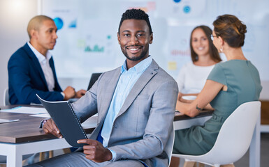 Portrait of a confident business man leading a meeting in a modern office, smiling and empowered. Happy black male discussing innovative strategies, marketing, planning and creative startup strategy