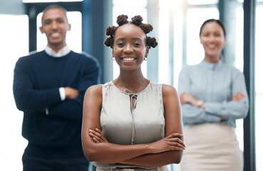 Leadership, female empowerment and proud business woman standing with her team and smiling with her arms crossed. Portrait of happy young black leader with a positive vision and mindset