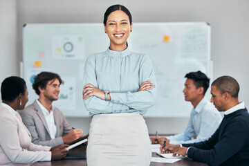 Female team leader, manager or boss standing confident with support of hard working employees, staff or colleagues. A woman with a group using teamwork, strategy and planning or discussing ideas