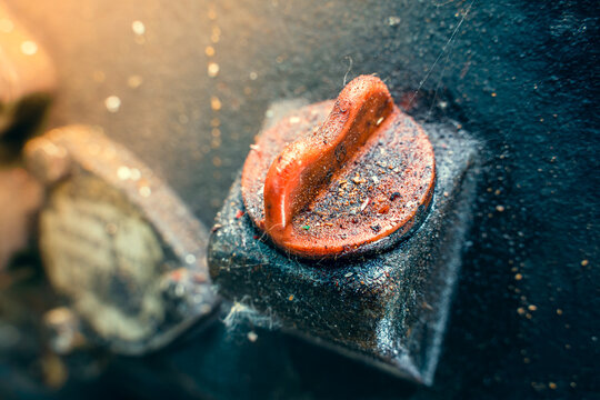 Close-up Red Plastic Oil Dipstick Cap In The Body Of A Dirty Motoblock Engine. Oil Filler Neck Of The Tractor. Oil Smudges And Adhering Dirt