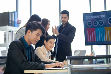 Asian business team male and female colleagues talking at work share ideas  with laptop, Happy colleagues work together on computer in office.