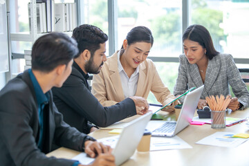 Asian business team male and female colleagues talking at work share ideas  with laptop, Happy colleagues work together on computer in office.