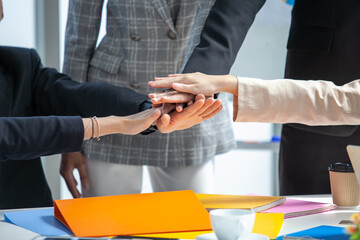 Teamwork Deal Cooperation Partnership business people giving hi-five before work in the office, touch hands for unity group to succuss business.