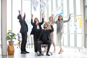 Asian business team celebrate corporate victory together in office, laughing and rejoicing, smiling excited employees colleagues screaming with joy in office. - 524383082