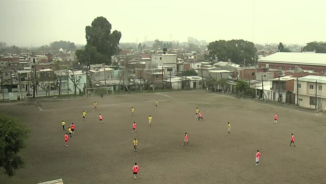 Men Playing Soccer in a Soccer Field at Villa Miseria 21-24 (Shanty Town) in Barracas District, Buenos Aires, Argentina.  