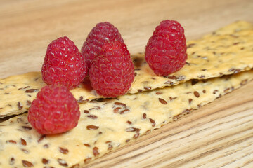 Ripe red raspberry is on the table