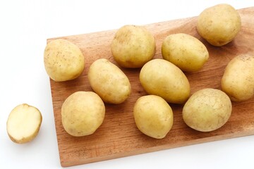 A pile of fresh organic baby potatoes, on white background. 
