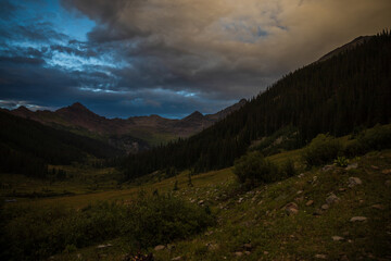 Alpine meadow at twilight with overcast glow
