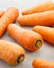 Fresh organic carrots on grey background.
