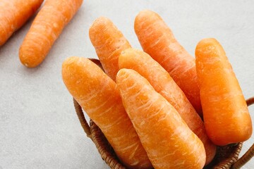 Fresh organic carrots on grey background.
