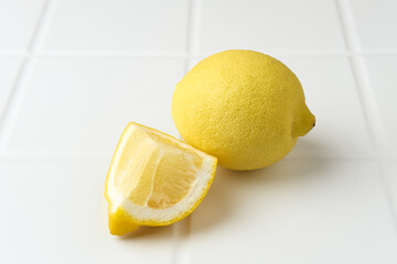 Fresh lemon fruits, lemon whole, half on the table. Selective focus.
