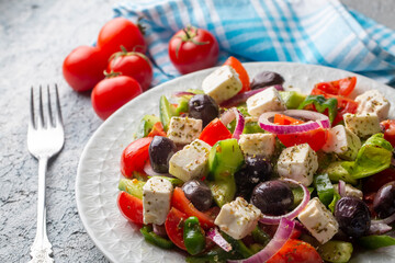 Greek salad with fresh vegetables, feta cheese and kalamata olives. Healthy food.