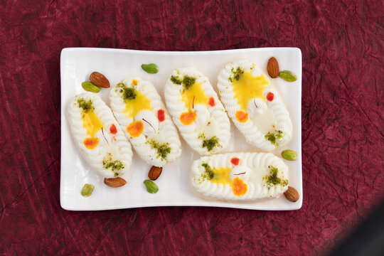 Cham Cham Mithai Also Called Rasgulla Malai Chaap, Chomchom Or Rosogolla Chamcham Is Made Of Milk, Mawa, Khoya, Pista, Kesar, Khova, Paneer, Chenna, Chhena, Dry Fruits Stuffing And Dunked In Chasni