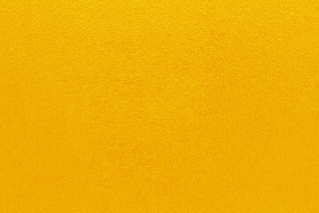 Naklejka premium Gold or yellow paint on cement wall texture background.
