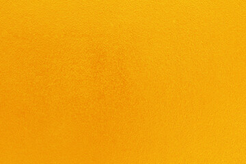 Gold or yellow paint on cement wall texture  background.