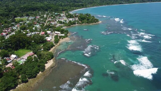 Puerto Viejo, Costa Rica: Aerial drone footage of the Puerto Viejo resort town, coastline and beach by the Caribbean sea in Costa Rica. Shot with a tilt up motion 